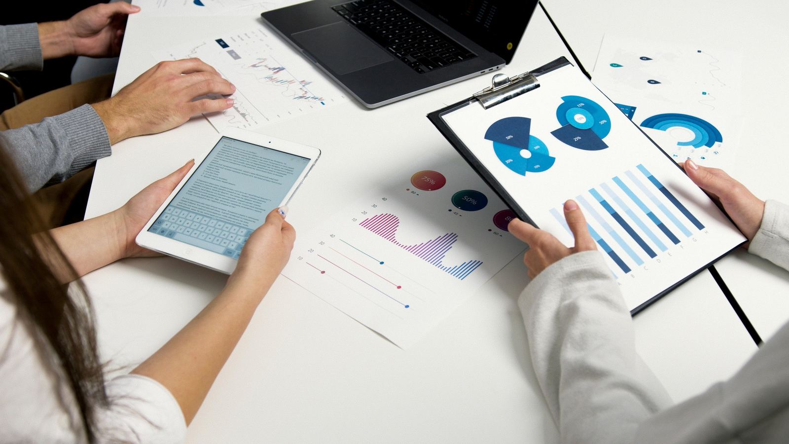 A tablet and analytics charts used during a meeting, showcasing how live streaming offers immediate feedback and valuable data
